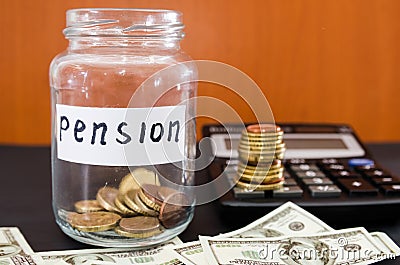 Coins in a glass jar, dollars and calculator on black. Saving money. Pension concept. Stock Photo