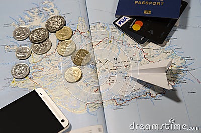 Coins of Iceland, the plane, smartphone, biometric passport, dollars, coins and credit cards Editorial Stock Photo