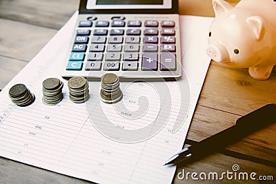 Coins, piggy bank and calculator on document Stock Photo