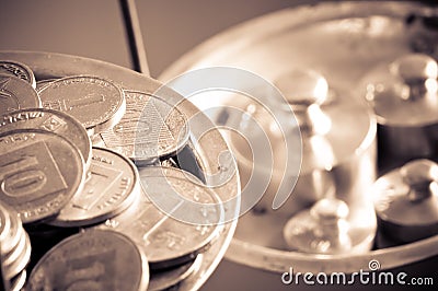 Coins on a scale weight Stock Photo