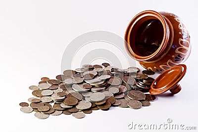 Coins spilling from the pot Stock Photo