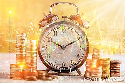 coins stack and alarm clock on golden background business concept overlay with financial graph stock with night street view Stock Photo