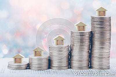 Coins stack in front of bank account book Savings money of coins concept concept for property ladder, Stock Photo