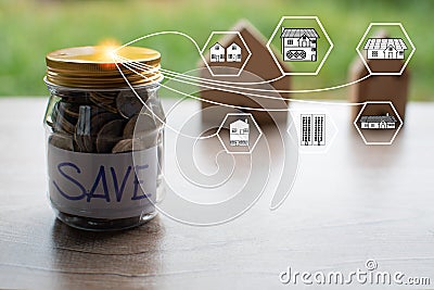 Coins and text SAVE in a glass jar placed on a wooden table. Concept of saving money for investment and buy a home Stock Photo