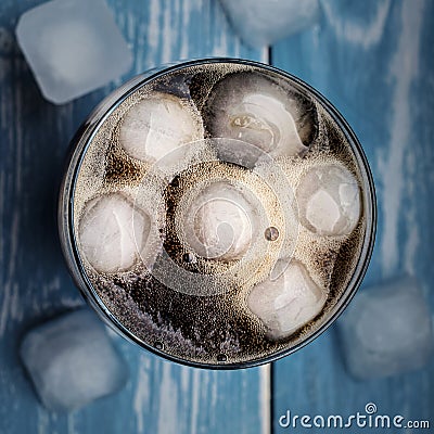 Cola in glass with ice from top. Stock Photo