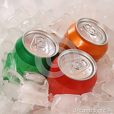 Cola and lemonade beverages in cans on ice Stock Photo