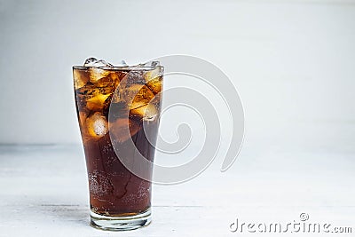 .Cola soda in a glass on a white table Stock Photo