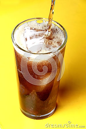 Cola soda poured into a glass with ice cubes Stock Photo