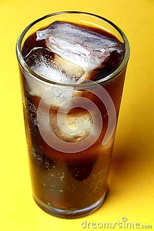 Cola soda poured in a glass with ice cubes Stock Photo