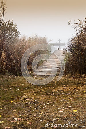 Cold autumn foggy morning near a beautiful fishing lake in Sic Stock Photo