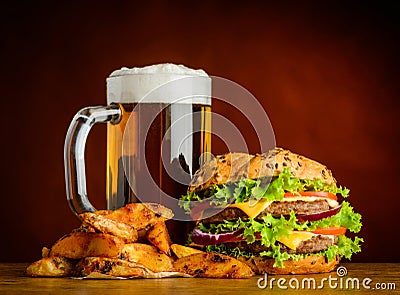 Cold Beer with Burger and Fried Potatoes Stock Photo