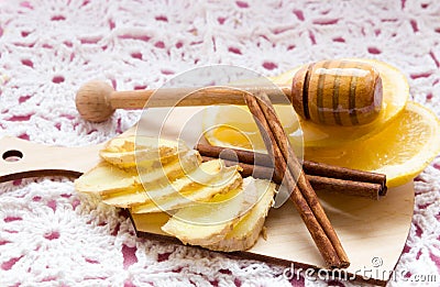 Cold care - honey, lemon, ginger, cinnamon on pink background Stock Photo