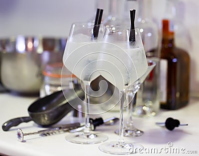 Cold cocktail with ice gin and tonic in glass goblets with straws Stock Photo