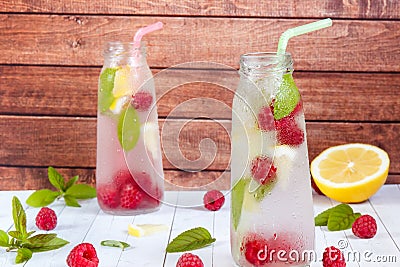 Cold cocktail with raspberries, lemon and mint. Wooden background Stock Photo