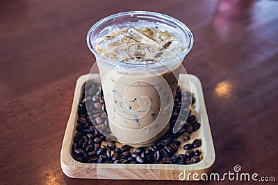 Cold coffee drink frappe or frappuccino in wooden tray with coffee bean Stock Photo
