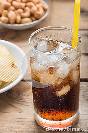 Cold cola iced drink in a glasses on a wood background. Stock Photo