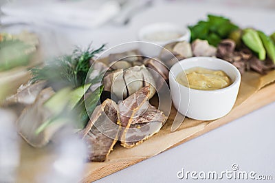 Cold cuts on a wooden chopping Board. Banquet at the restaurant. Stock Photo