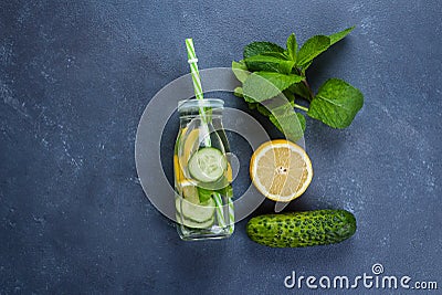 Cold detox water with lemon, cucumber and mint in glass bottle. Top view with copy space Stock Photo