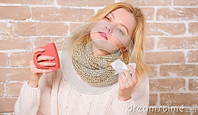 Cold and flu symptoms. Sick woman with sore throat drinking cup of warm tea. Pretty girl with nasal cold suffering from Stock Photo