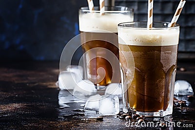 Cold frappe coffee with ice and foam in large glasses on brown b Stock Photo