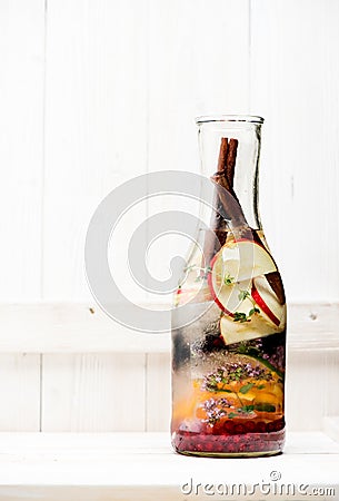 Cold Infused Detox Water with berries, herbs and fruits in a glass bottle Stock Photo