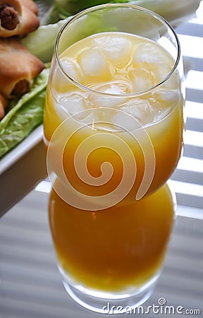 Cold orange juice in a glass on the table Stock Photo