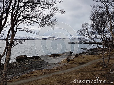 Cold and overcast day in northern norway with snowy mountains and calm seas Stock Photo