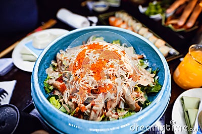 Cold platter in a blue bowl with avocado and crab meat flavored with orange spice Stock Photo