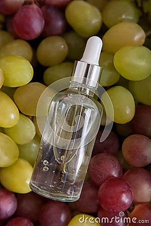 Cold pressed grape oil. Organic bio care products with natural ingredients. Close-up grapes and copy space. Halved grapes and grap Stock Photo