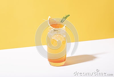 Cold and refreshing orange punch cocktail with orange slice on yellow background. summer drink Stock Photo