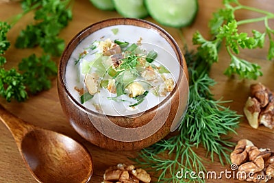 Cold soup Tarator with kefir in a wooden bowl Stock Photo