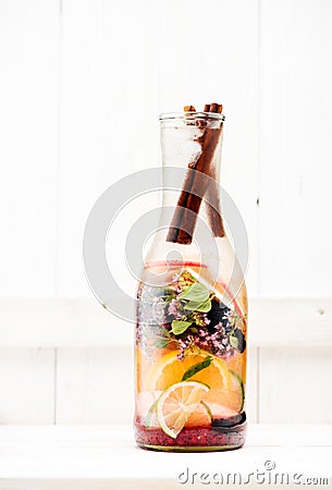 Cold Summer lemonade with berries, herbs and fruits in a glass bottle Stock Photo