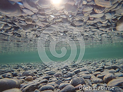 Cold underwater river bed with perfect reflection on surface tension Stock Photo