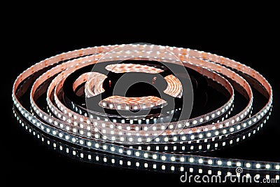 Cold white LED strip on reel with black background Stock Photo