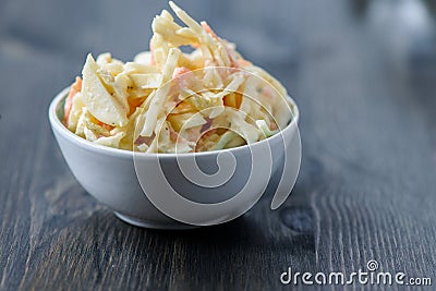 Coleslaw in a bowl on a wooden table Stock Photo