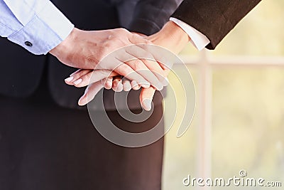 Collaborative concepts, young businessmen join hands to show unity, teamwork is a success. Stock Photo
