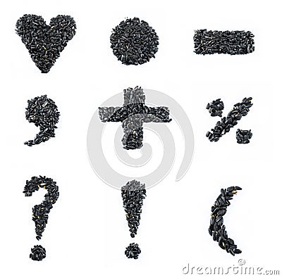 Collage of black sunflower seeds forming symbols Stock Photo
