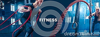 Men with battle rope battle ropes exercise in the fitness gym. Stock Photo