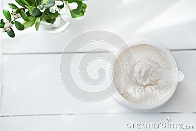 Collagen or protein in powder on white wooden table Stock Photo