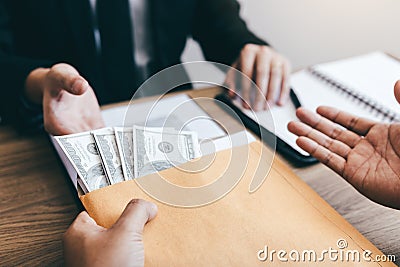 Colleague came to offer the project for work in future and agreed by giving money to bribe the businessman in office room Stock Photo