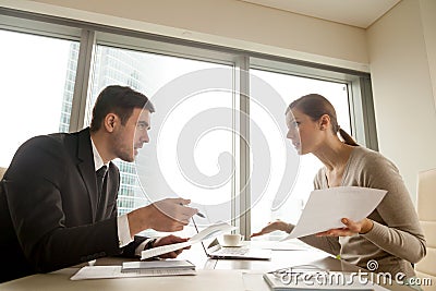 Colleagues arguing at workplace, disagree about document, error Stock Photo