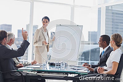 Colleagues asking a question to a businesswoman Stock Photo