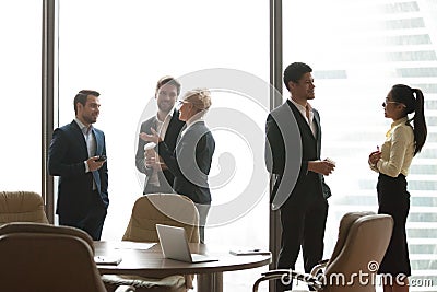 Colleagues having casual talk during work break in office Stock Photo