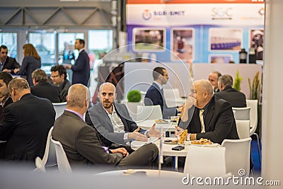 Colleagues having a drink attending the Amper event at the convention trade center in Brno. BVV Brno Exhibition center. Czech Editorial Stock Photo