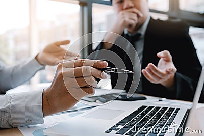 Colleagues are stress talking about the results report and compared with the financial information on the laptop screen Stock Photo