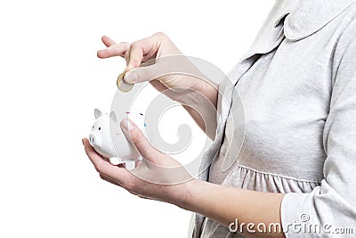 Collect money concept. Close-up of woman throws coin in piggy bank isolated on white background. Saving money Stock Photo