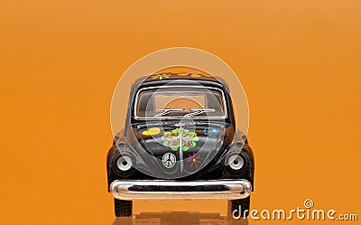 Collectible toy model car Volkswagen Beetle decorated in Hippie lifestyle. Front view Editorial Stock Photo