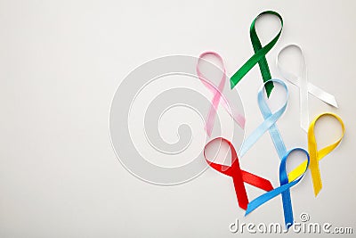 Collection of awareness ribbons on grey with copy space. World cancer day Stock Photo