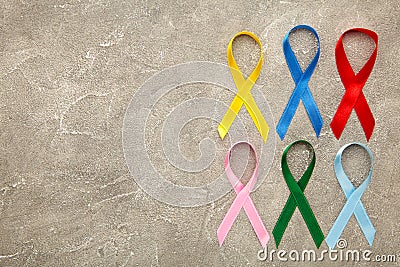 Collection of awareness ribbons on grey. World cancer day Stock Photo
