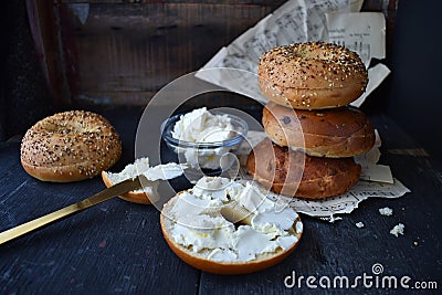 Assorted Bagels with cream cheese on rustic table with music sheets horizontal layout Stock Photo